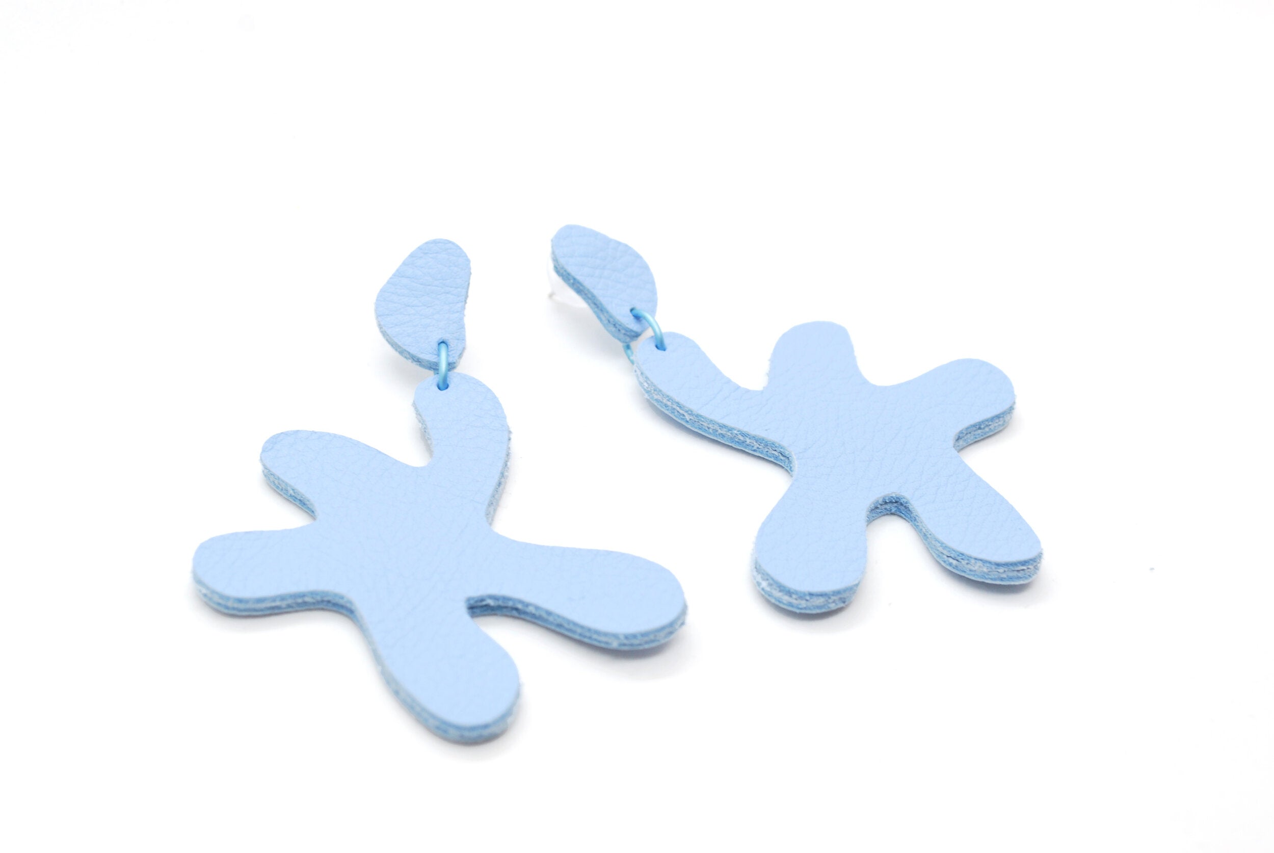 sky blue leather earrings made of cutout organic shapes and anodized aluminum jump rings.