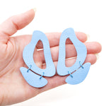 the inferno leather cutout statement earrings in soft blue.