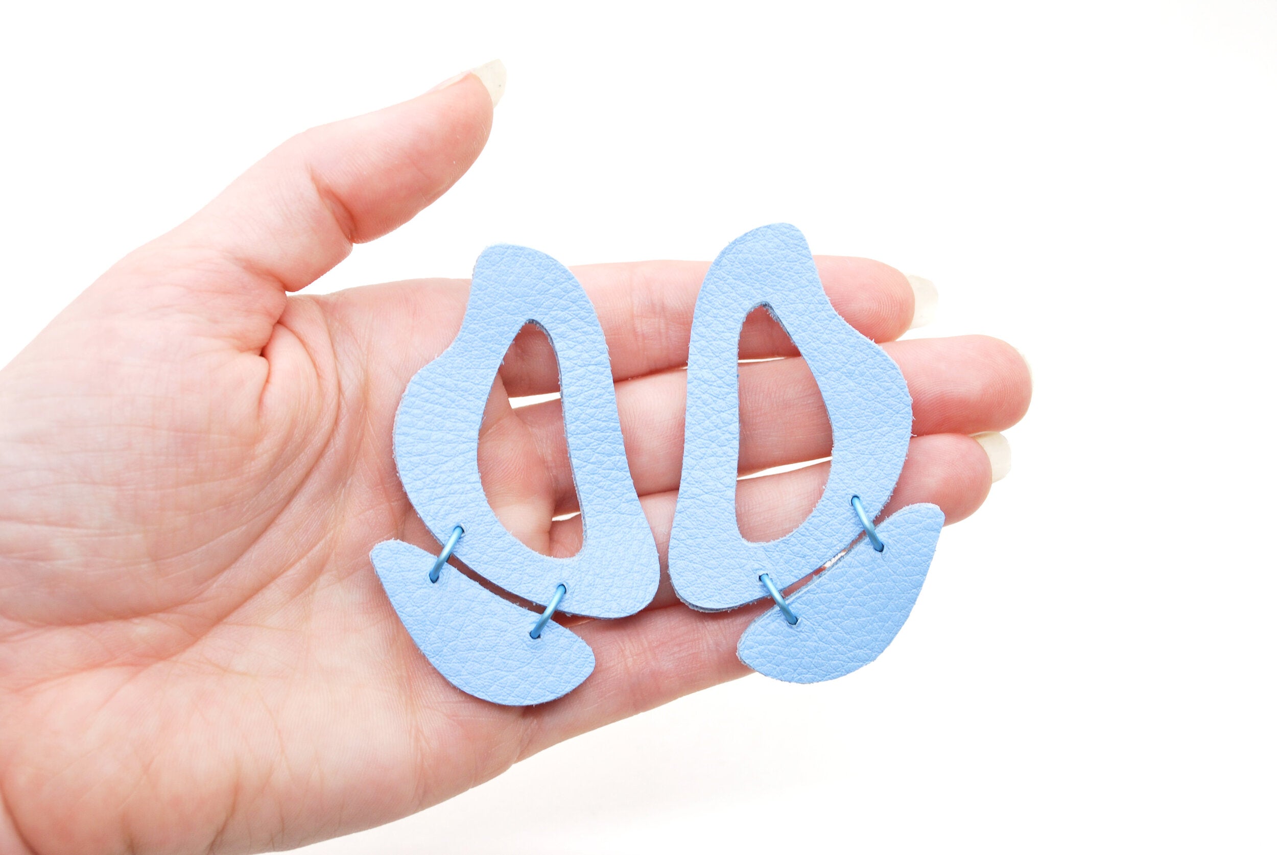 the inferno leather cutout statement earrings in soft blue.