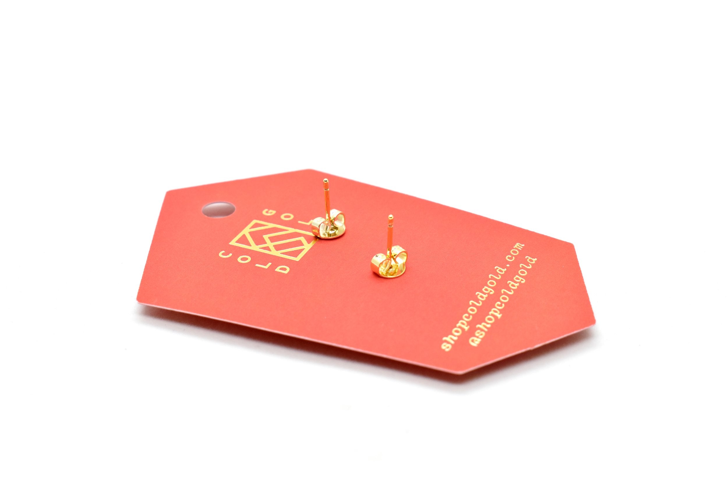 back of the card holding gold half moon stud earring set in ruby red clay with sterling silver posts that are good for sensitive ears