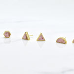 set of three geometric earrings in candy pink swirls in hexagon, triangle, and half moon shapes with gold accents and studs.