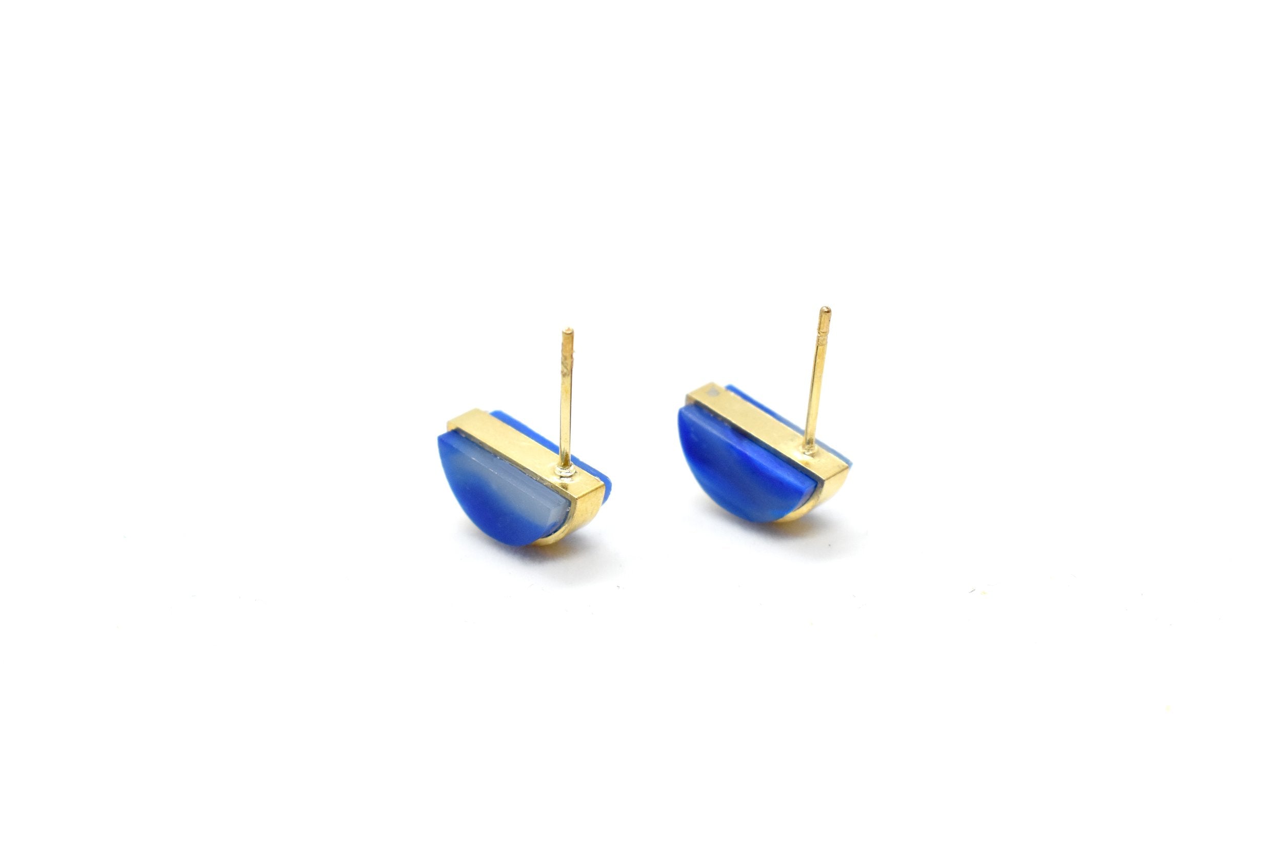 a pair of tiny gold studs flipped over to show the surgical steel post, they are marbled polymer clay gold earrings in sapphire color birth stone virgo jewelry gemstone earrings