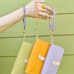 three catch all wallets hanging from matching keychains