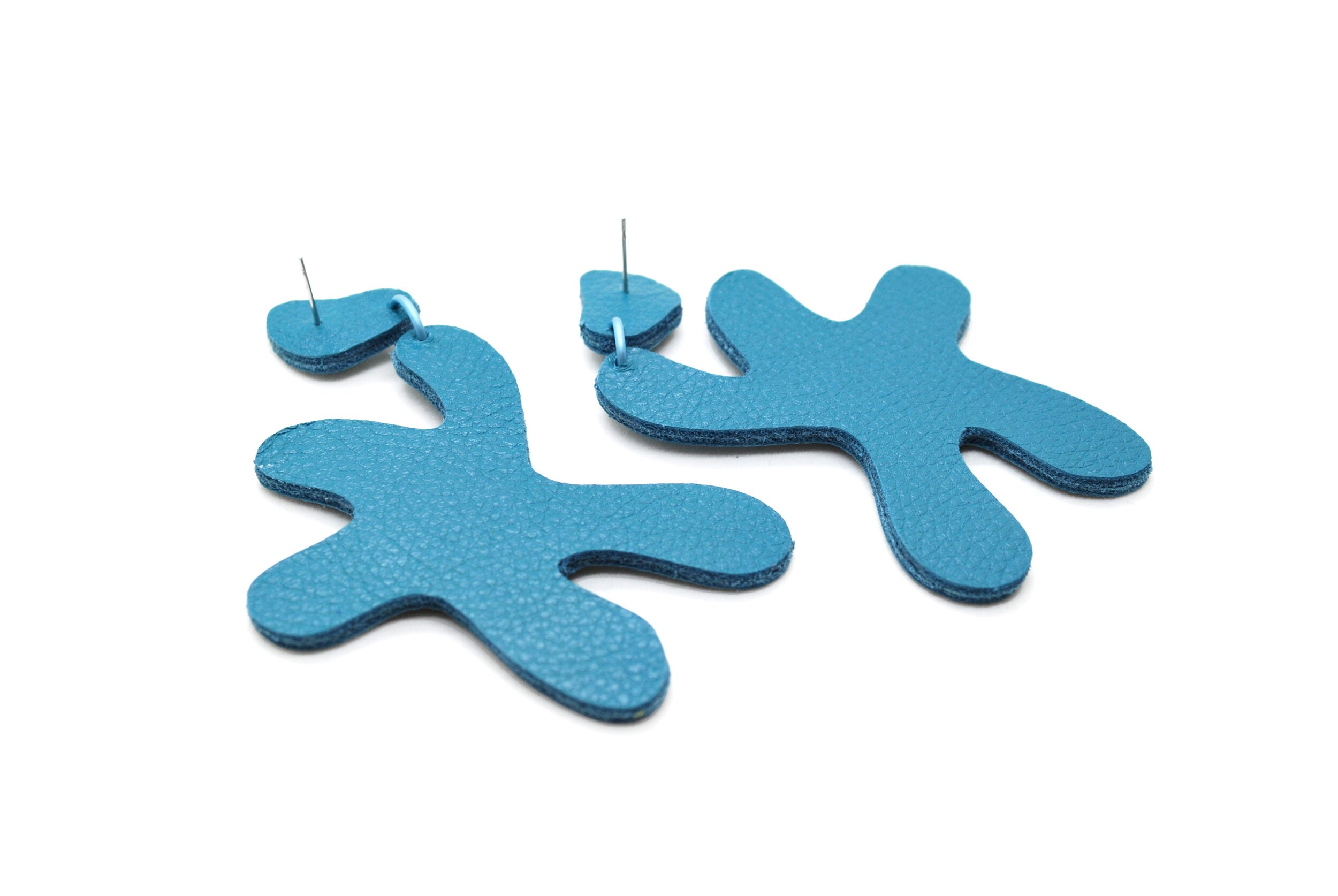monochrome leather star shaped earrings in teal.