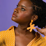 marigold matisse inspired leather statement earrings on a young woman