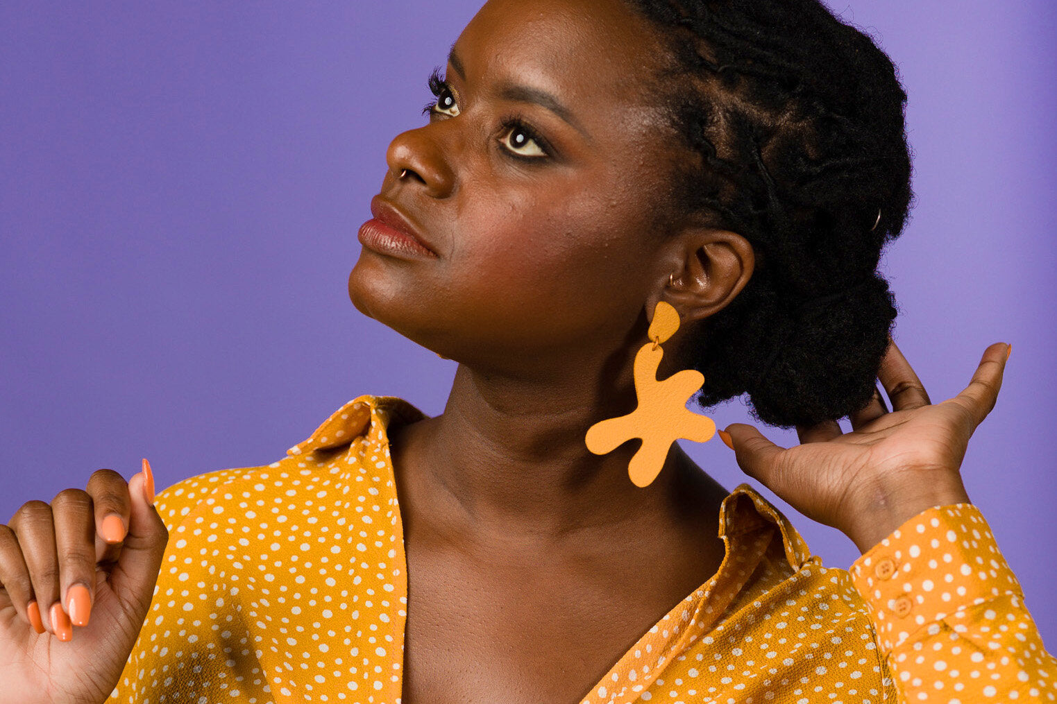 marigold matisse inspired leather statement earrings on a young woman